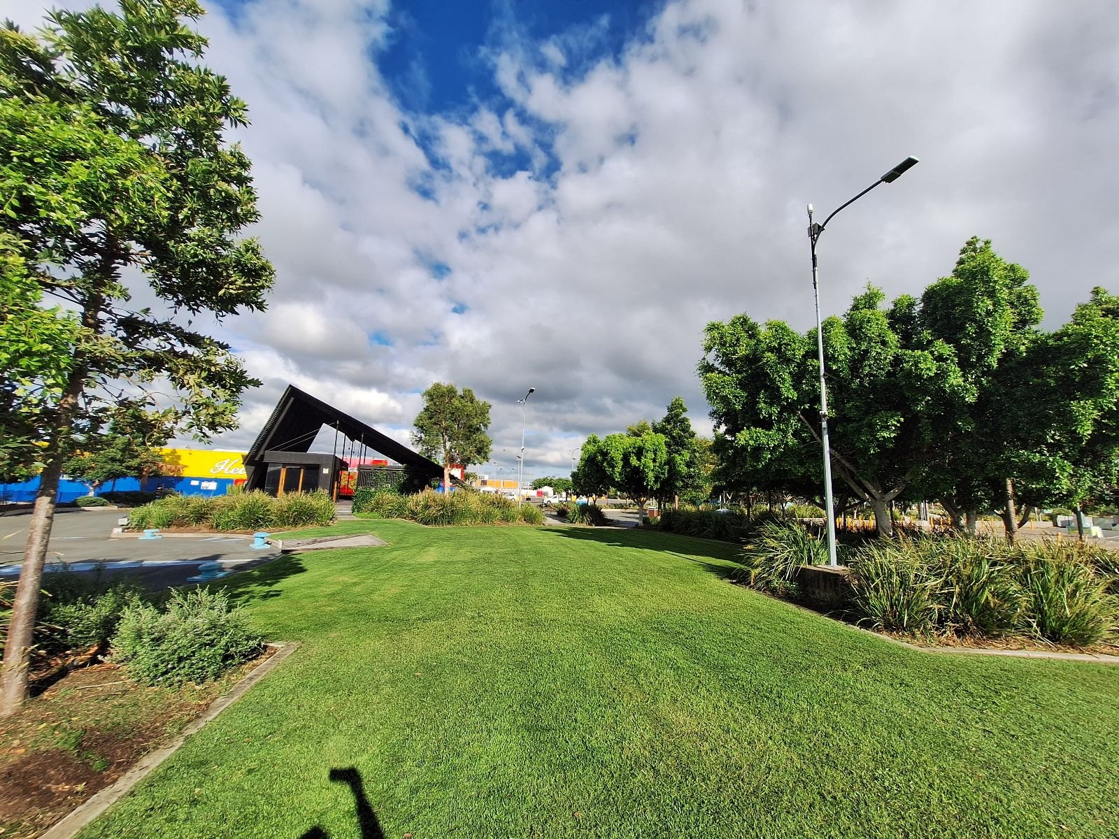 A pristine commercial landscape under blue skies — what premium care looks like